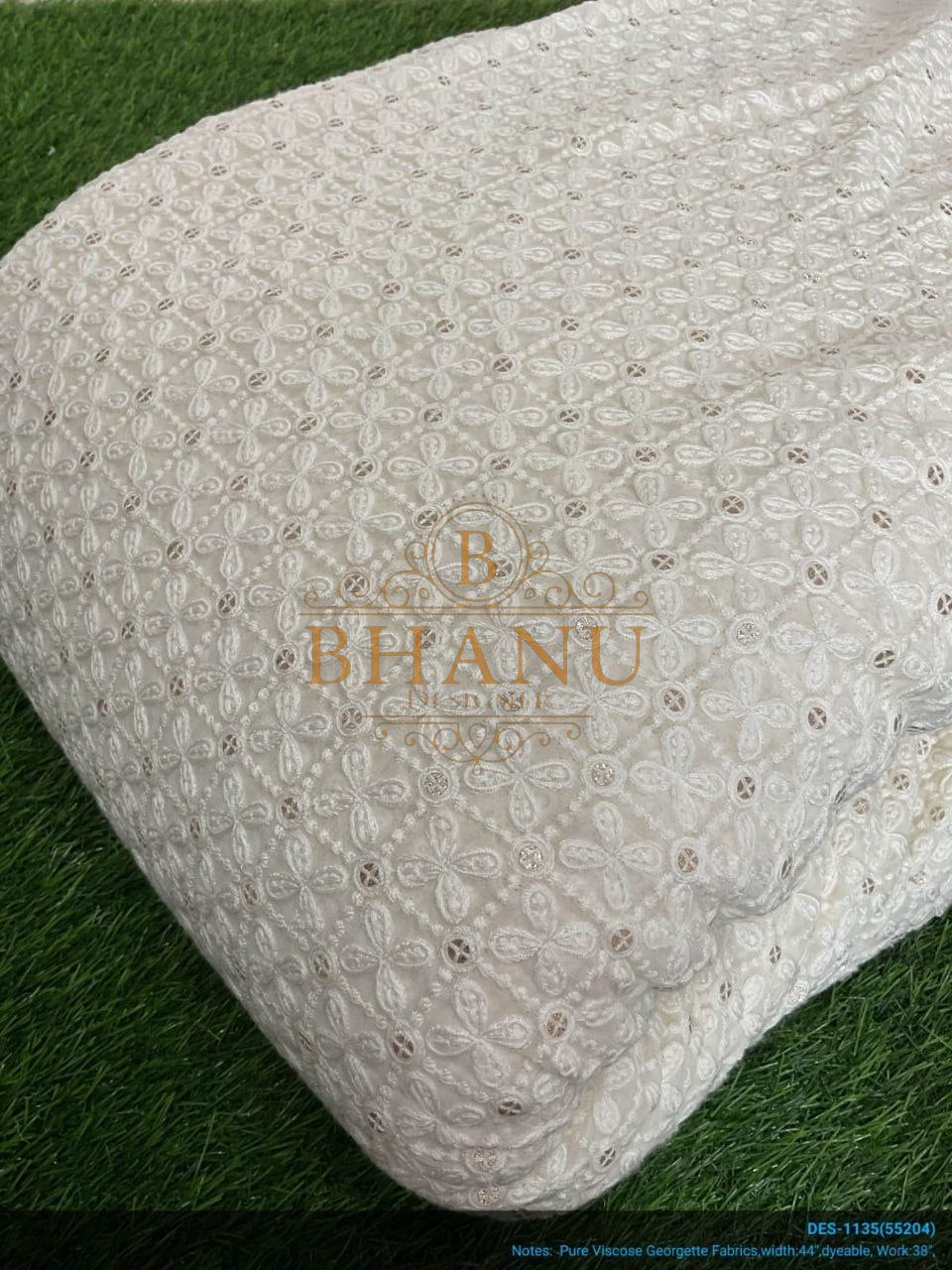 Ivory with tonal cutwork, folded - fabric by the metre