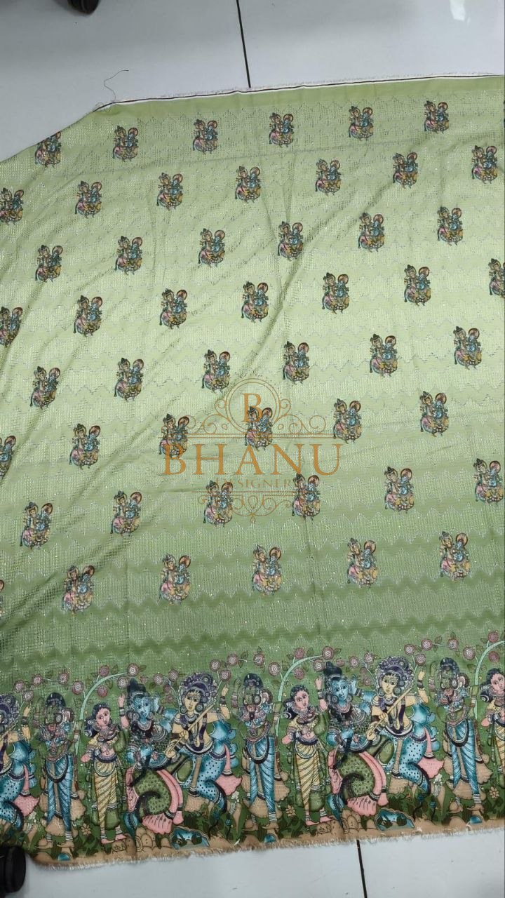 Pale green with butti and a multicolour hem - fabric by the metre