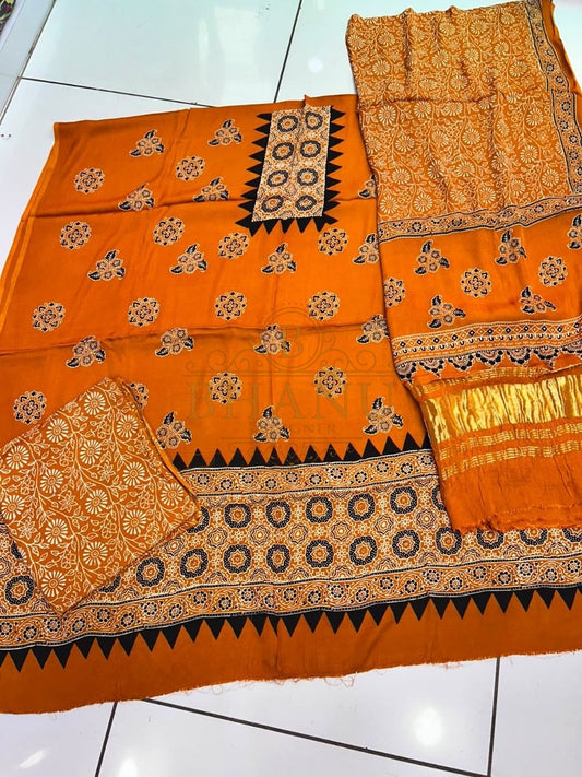 Orange with a black and gold print - fabric by the metre