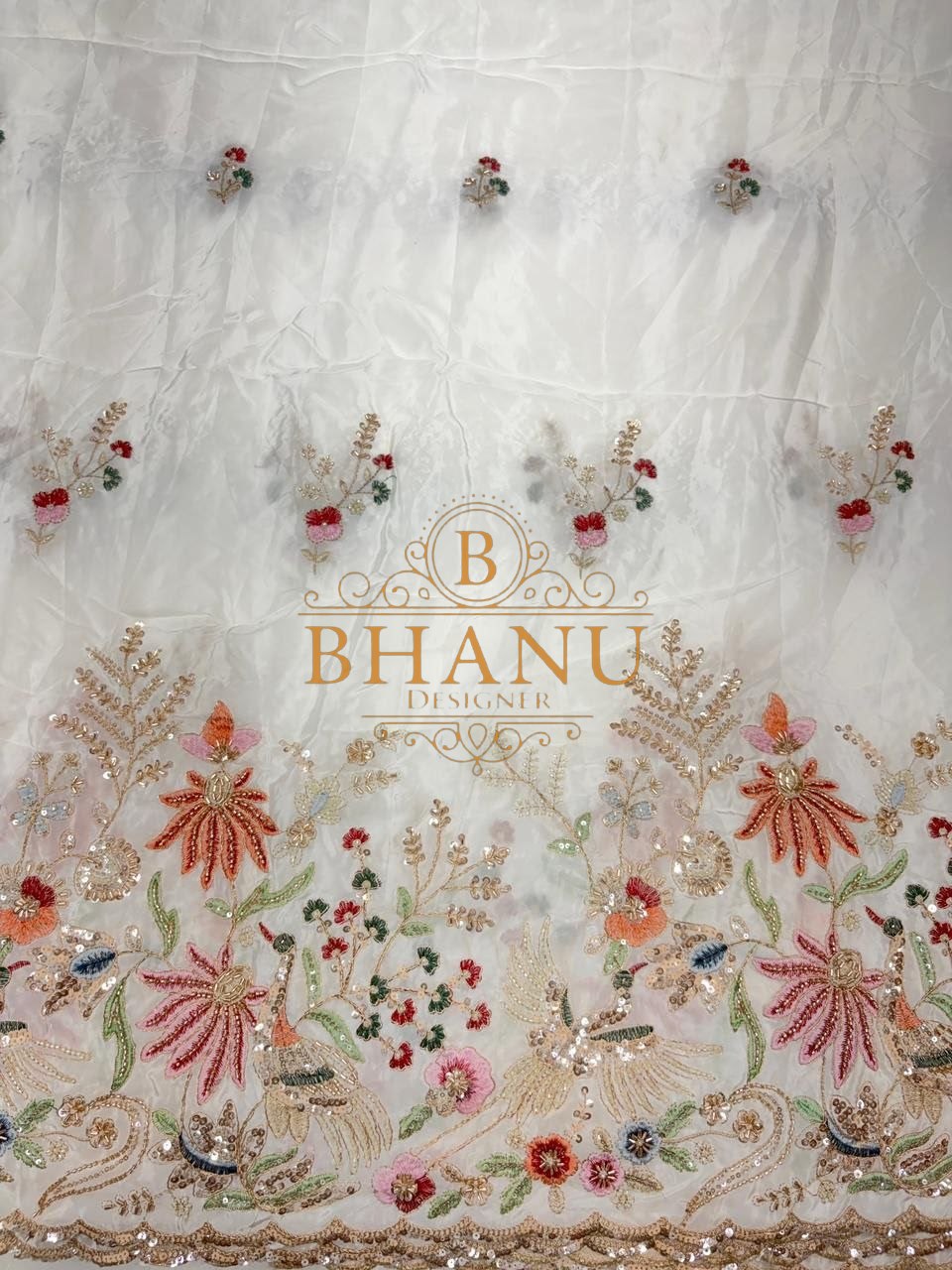 Ivory with a multicolour floral hem - fabric by the metre