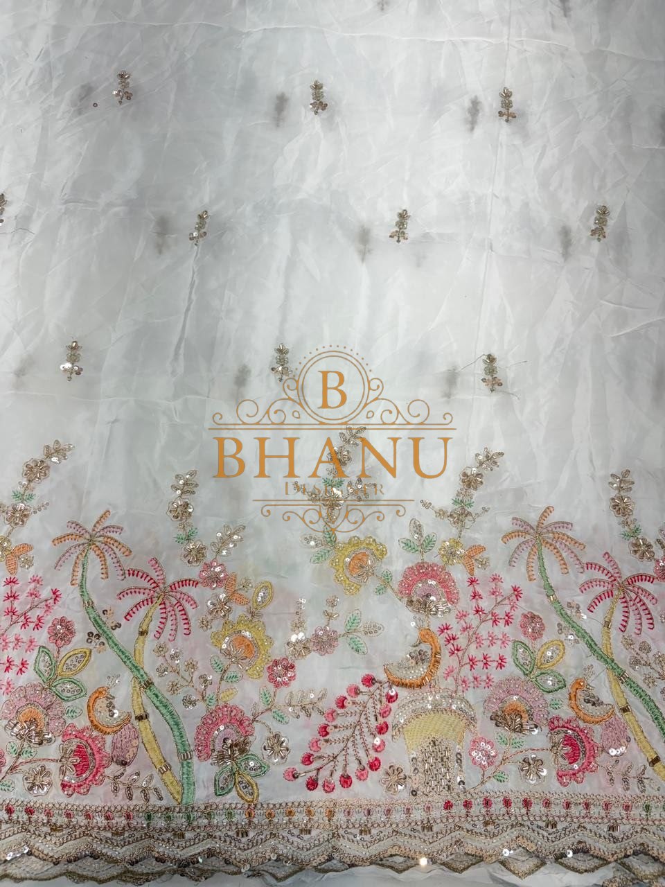 Ivory with a multicolour floral hem - fabric by the metre