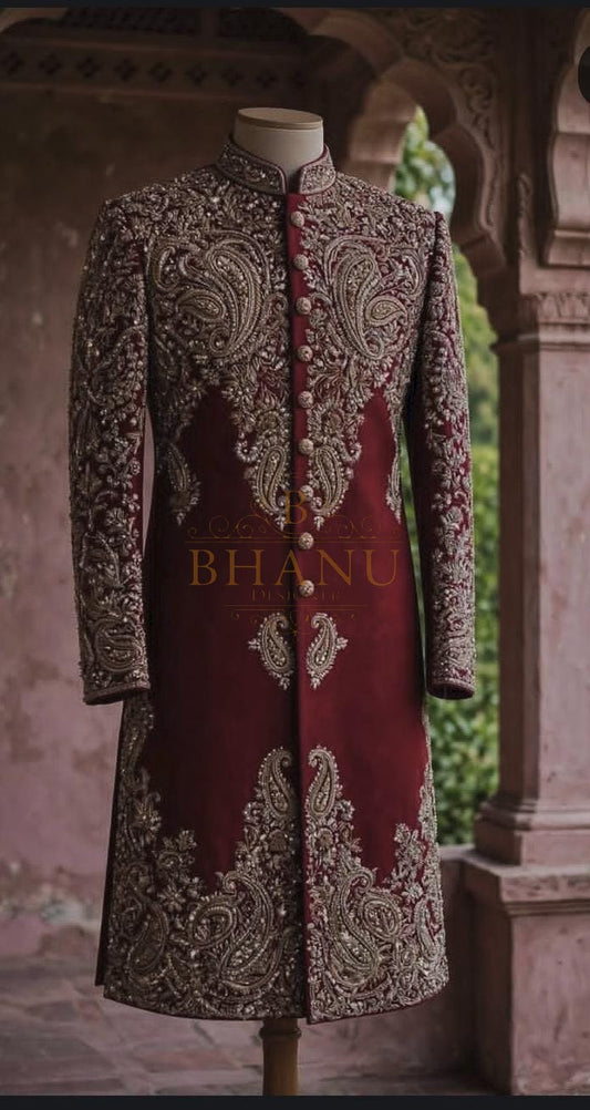 Maroon rajwadi sherwani with heavy gold work across the yoke and front panels