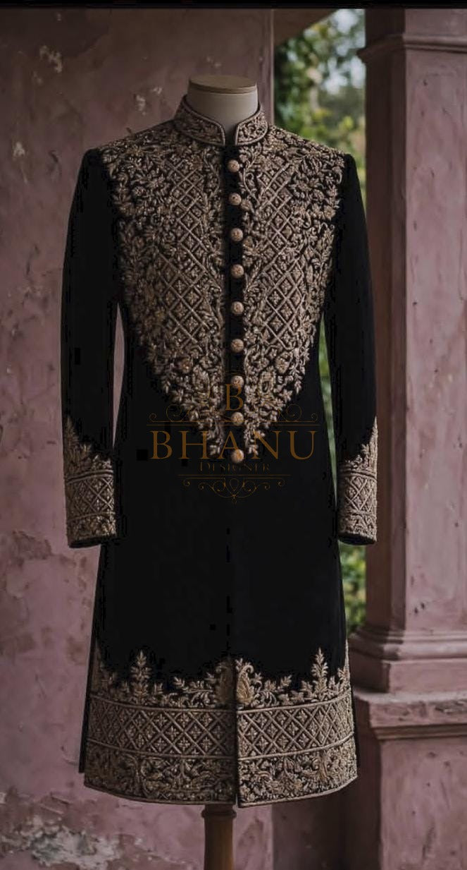 Black rajwadi sherwani with a heavy gold yoke panel and matching hem band