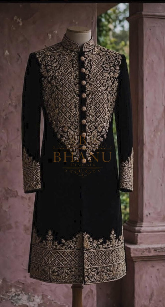 Black rajwadi sherwani with a heavy gold yoke panel and matching hem band