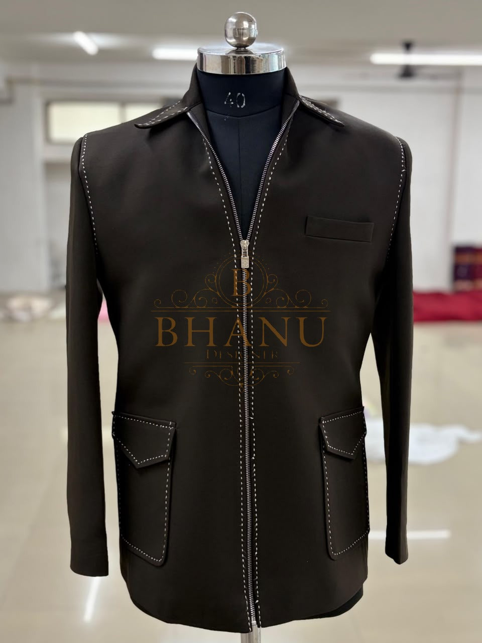 The zip-front jacket on a mannequin in the workshop