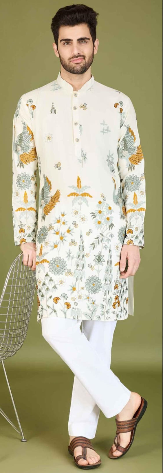 Man wearing a navy blue kurta with floral patterns on a beige background
